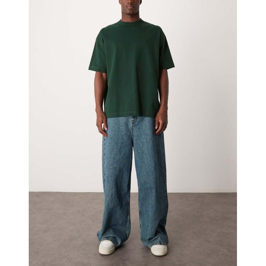 ASOS DESIGN - Jeans met lage taille, losse pasvorm en wijde zoom in zware gemarmerde blauwe wassing Blauw