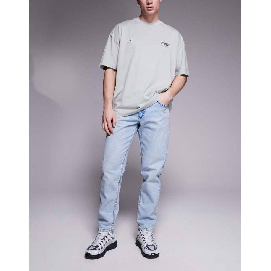 ASOS DESIGN - Jeans met smaltoelopende pasvorm in blauw met lichte wassing Blauw